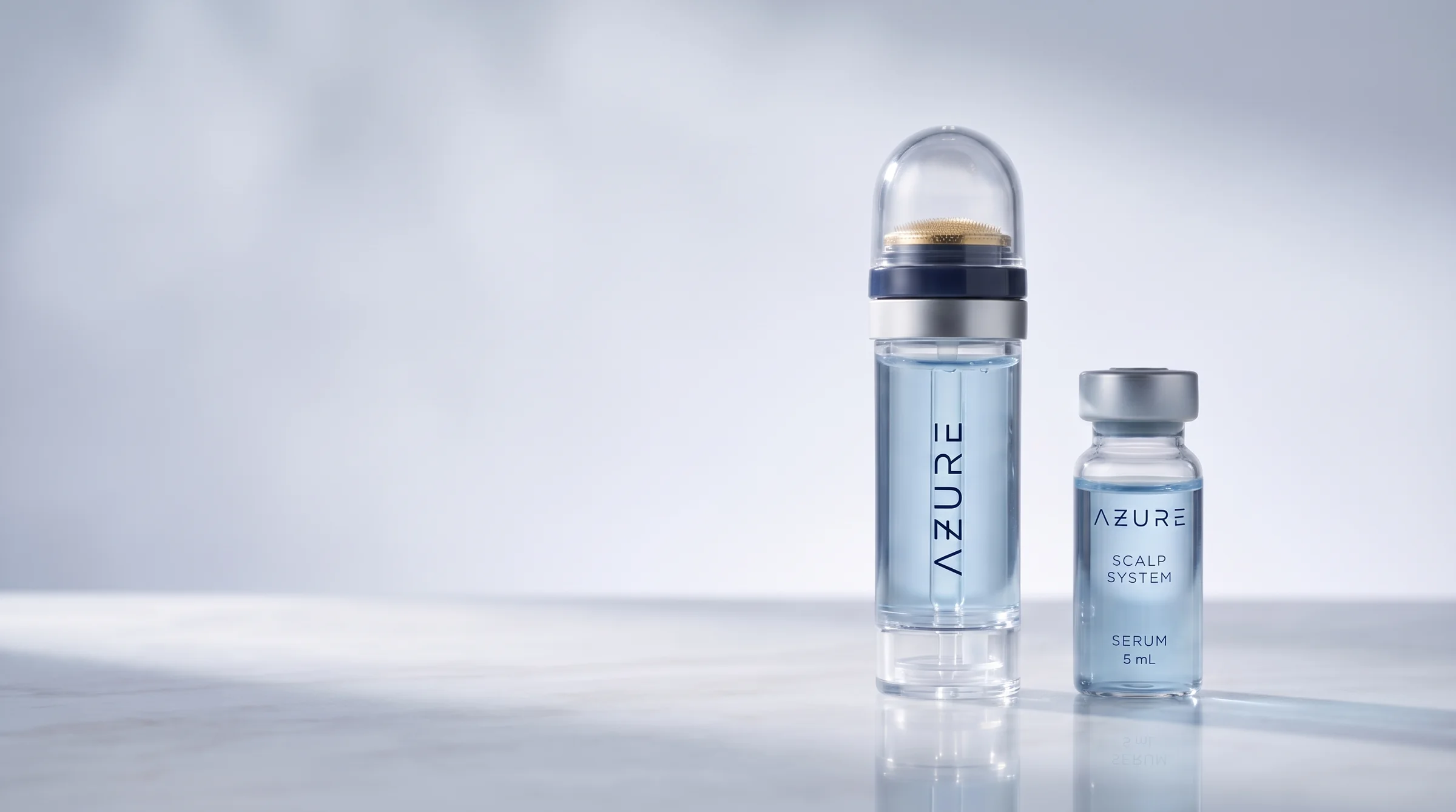 The AZURE micro-infusion applicator and a 5 mL vial of blue serum standing on pale polished stone in soft daylight