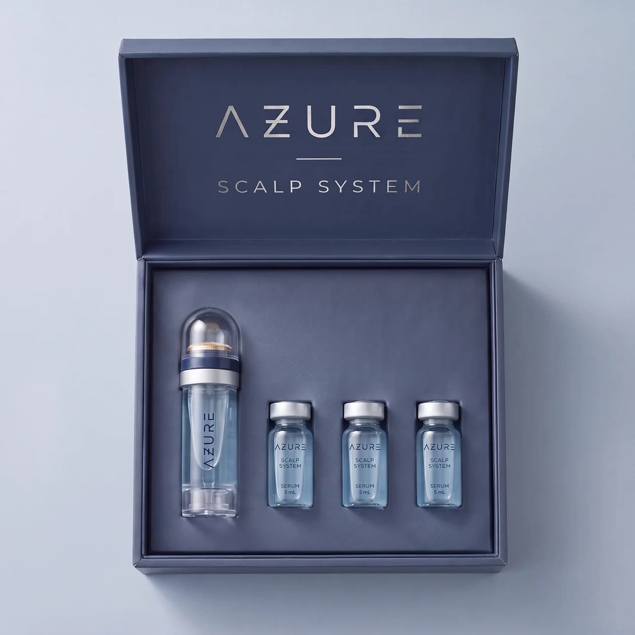 Open navy AZURE presentation box with the applicator and three glass serum vials